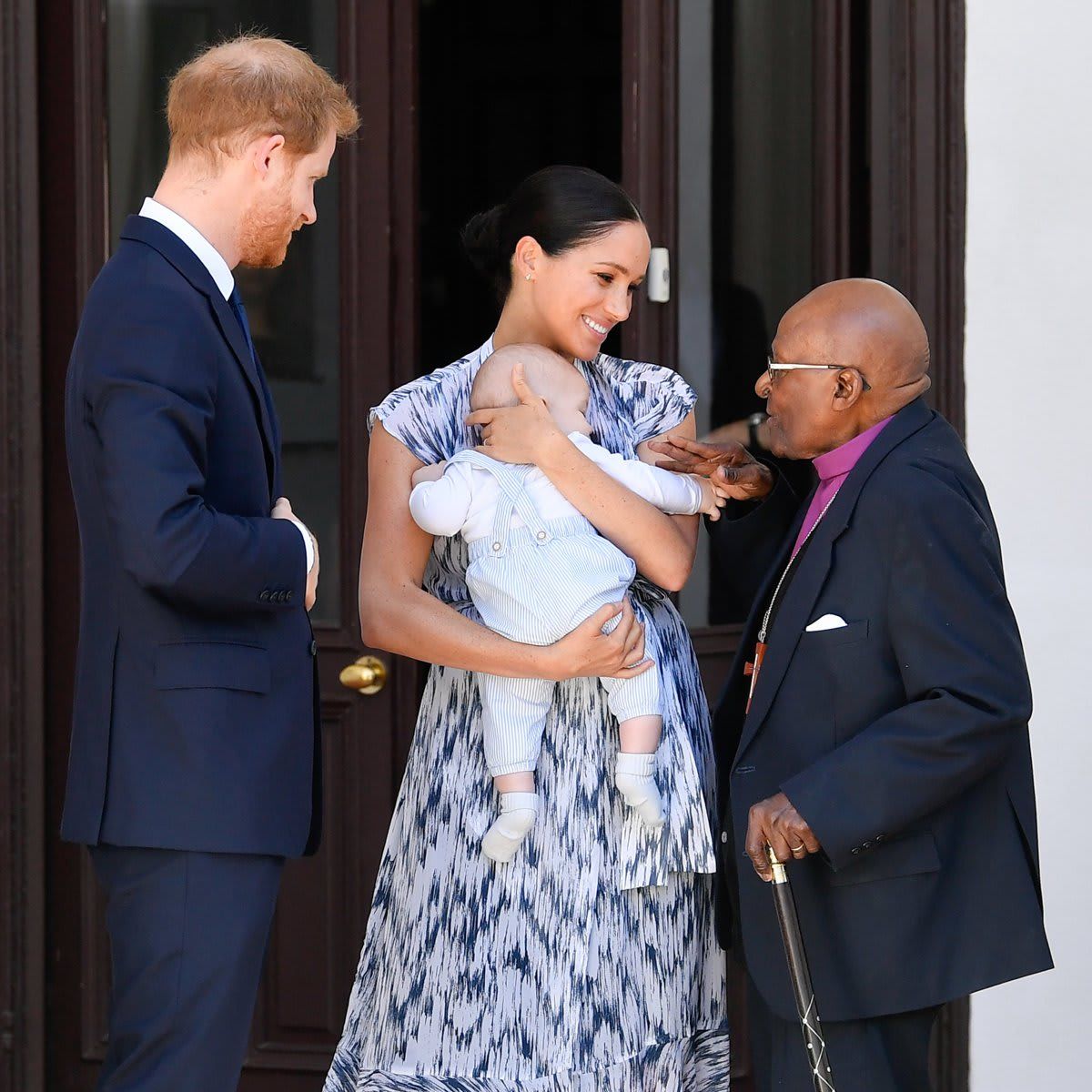 Archbishop Desmond Tutu (pictured with Meghan, Harry and Archie in 2019) died on Dec. 26