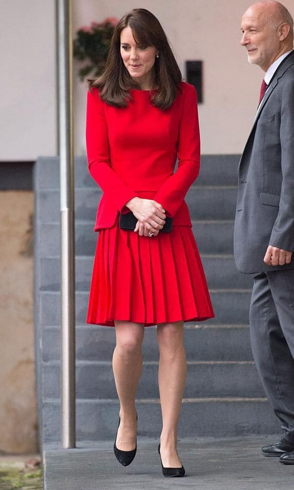 Kate Middleton in a red pleated skirt and jacket set in 2015