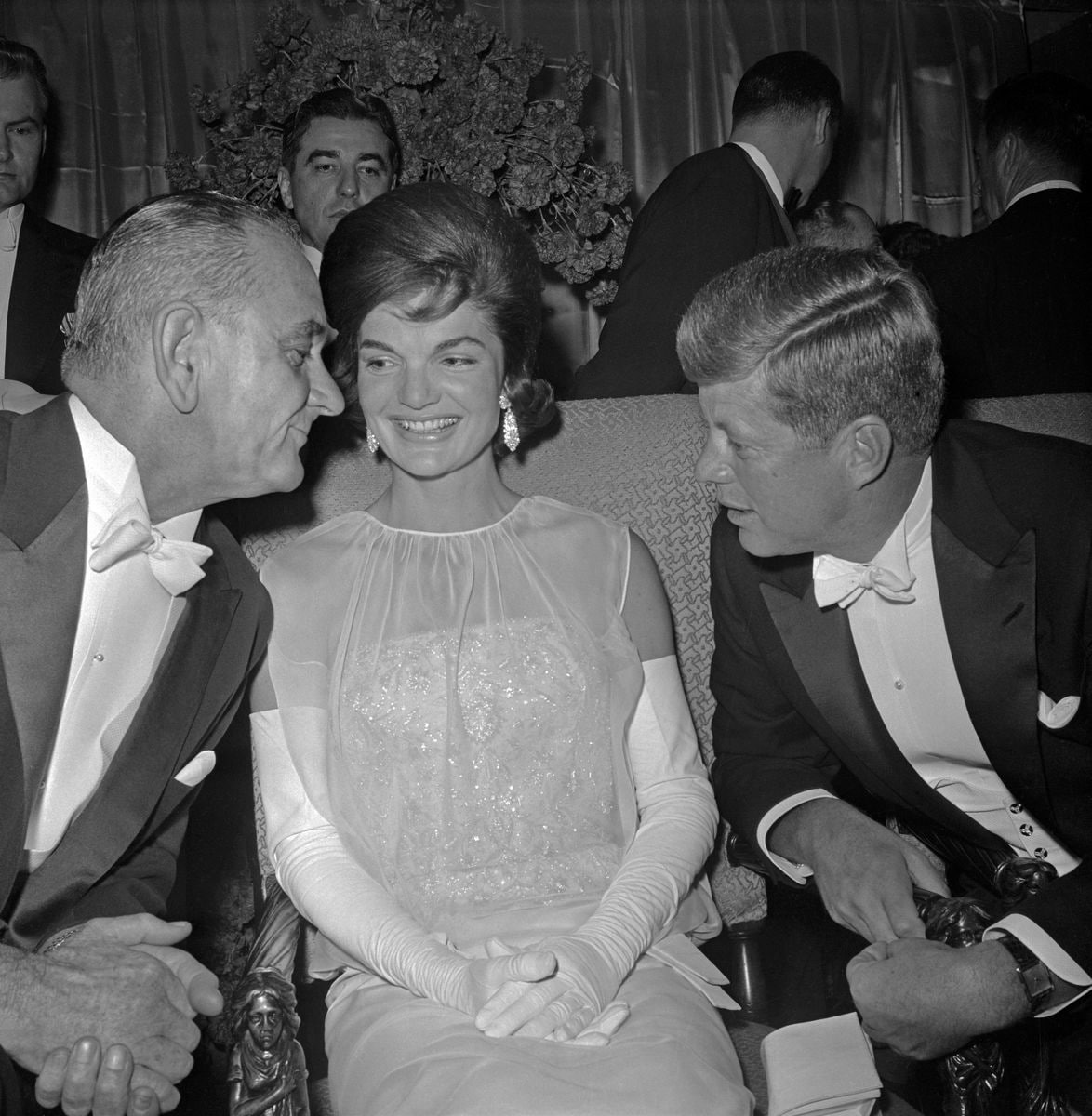 Vice President Lyndon B. Johnson chats with the President and Mrs. Kennedy at the inaugural ball 