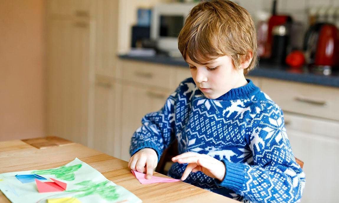 Child making a paper card