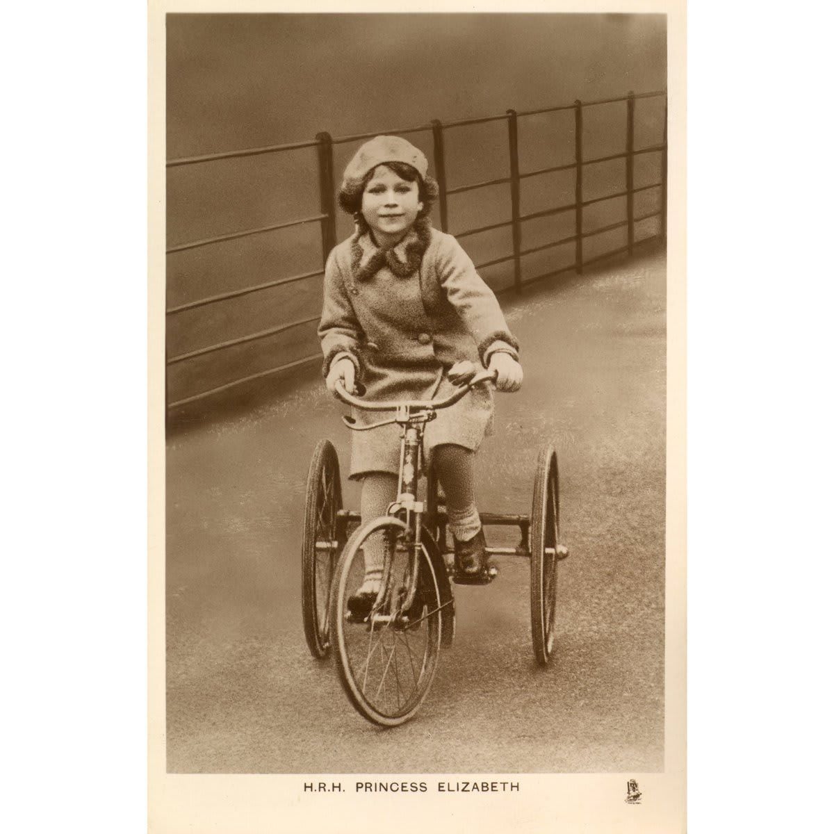 Keep calm and cycle on! Future Queen Elizabeth was pictured riding her tricycle in a park.