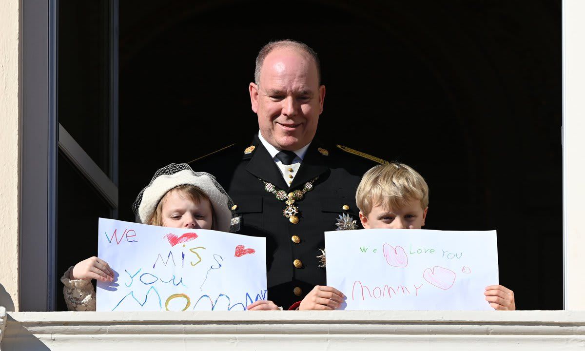 Princess Gabriella and Prince Jacques held up signs for their mother Princess Charlene