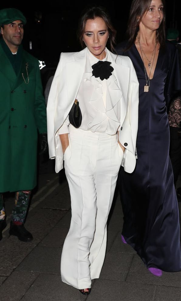 Victoria Beckham with white tailored suit and black floral bow tie