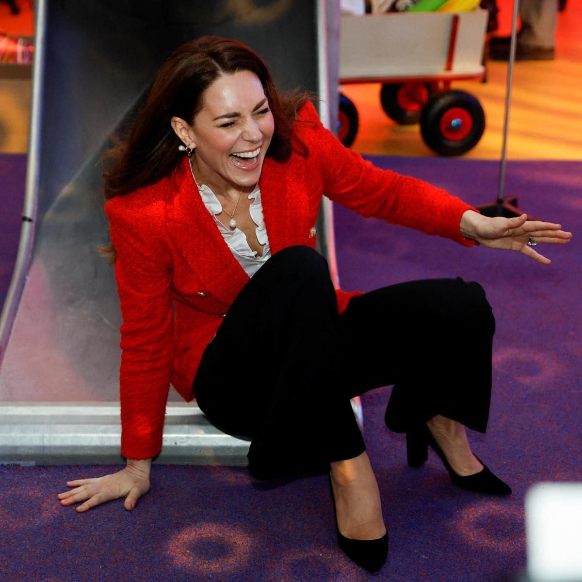 The Duchess of Cambridge laughed after going down a slide at the LEGO Foundation PlayLab