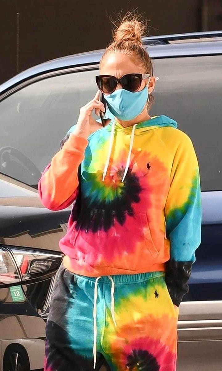 Jennifer Lopez walking the streets of NYC in a tie-dye outfit.