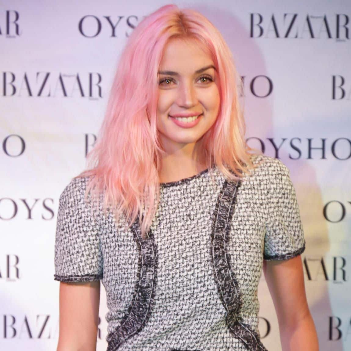 Ana de Armas smiling with her pink look