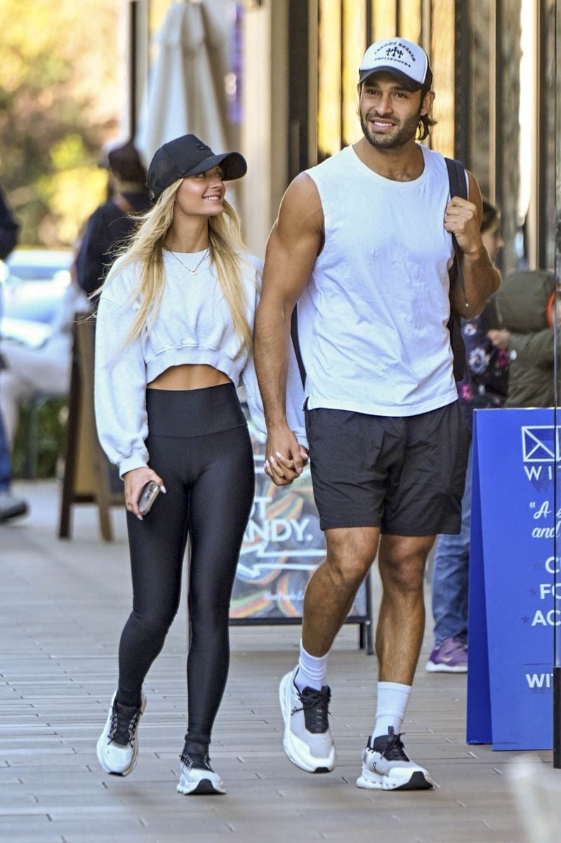 American model and actor Sam Asghari and his girlfriend Brooke Irvine left the gym smiling in Studio City, Los Angeles. The couple held hands while sporting matching black and white sports outfits, exuding happiness and style.