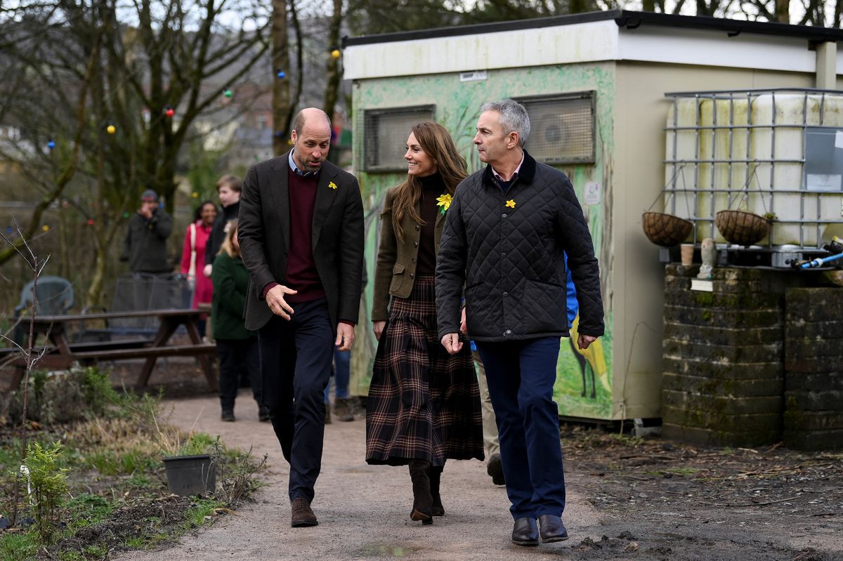 PONTYPRIDD, WALES - FEBRUARY 26: Prince William, Prince of Wales and Catherine, Princess of Wales walk with Lord Lieutenant of Mid Glamorgan Peter Vaughan during a visit to Meadow Street Community Garden and Woodland on February 26, 2025 in Pontypridd, Wales. In December 2024, Pontypridd was one of a number of towns across Wales which was hit by severe flooding as a result of Storm Bert and Storm Darragh. The Prince and Princess met with local residents, learning about their experiences and the impact of recent events in the town. (Photo by Jaimi Joy - WPA Pool/Getty Images)