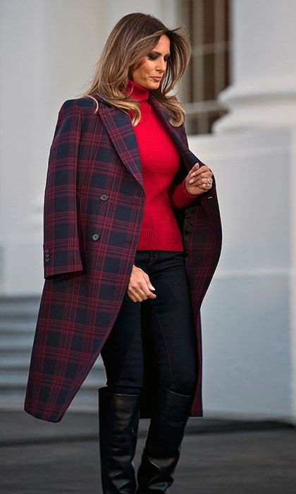 To receive the delivery of the White House Christmas tree alongside son Barron on November 20, First Lady Melania dressed down in a red sweater, dark trousers and knee-high leather boots. Completing the cold-weather ready outfit was a red and navy blue plaid coat by Calvin Klein.
Photo: BRENDAN SMIALOWSKI/AFP/Getty Images