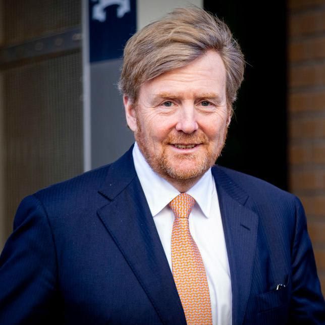 King Willem-Alexander of the Netherlands walks and smiles at the camera