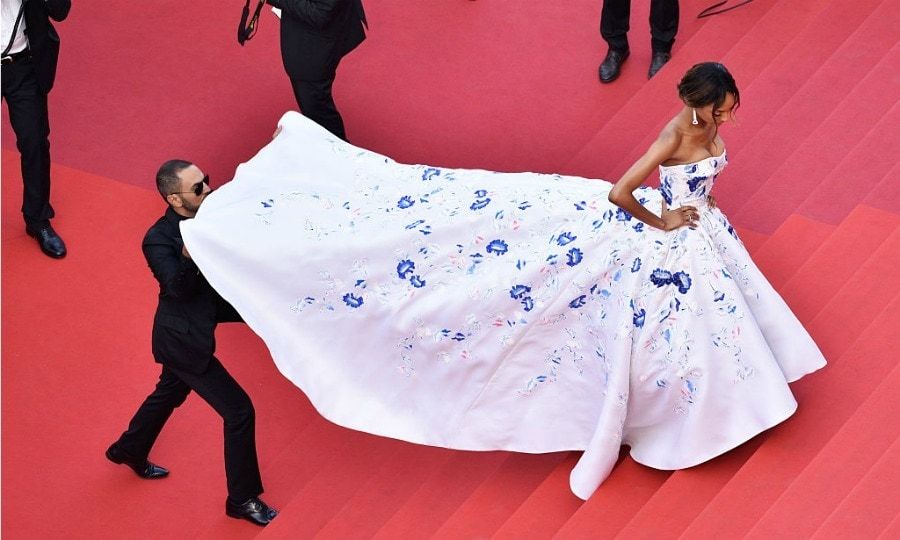 The model required a bit of assistance making her way up the carpet steps in her voluminous gown.
<br>
Photo: Clemens Bilan/Getty Images