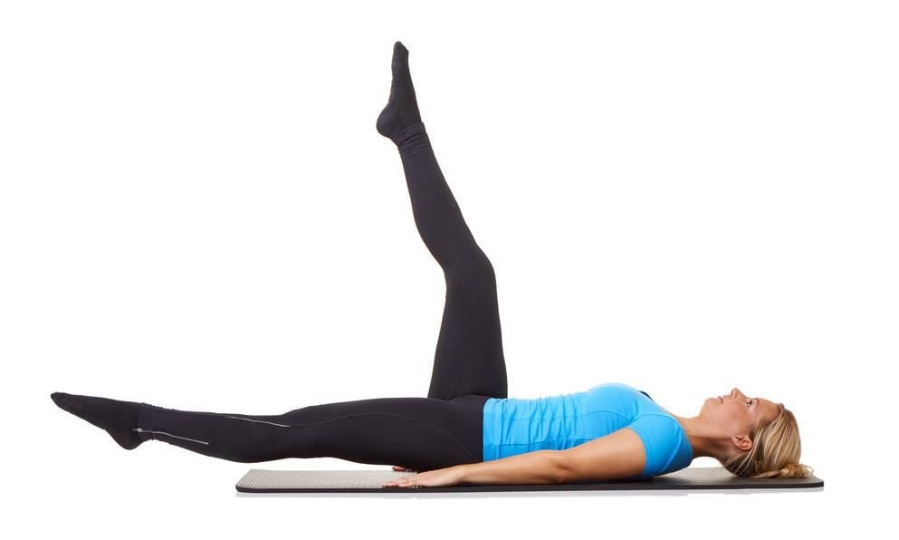 Woman doing an ab exercise, lifting her legs