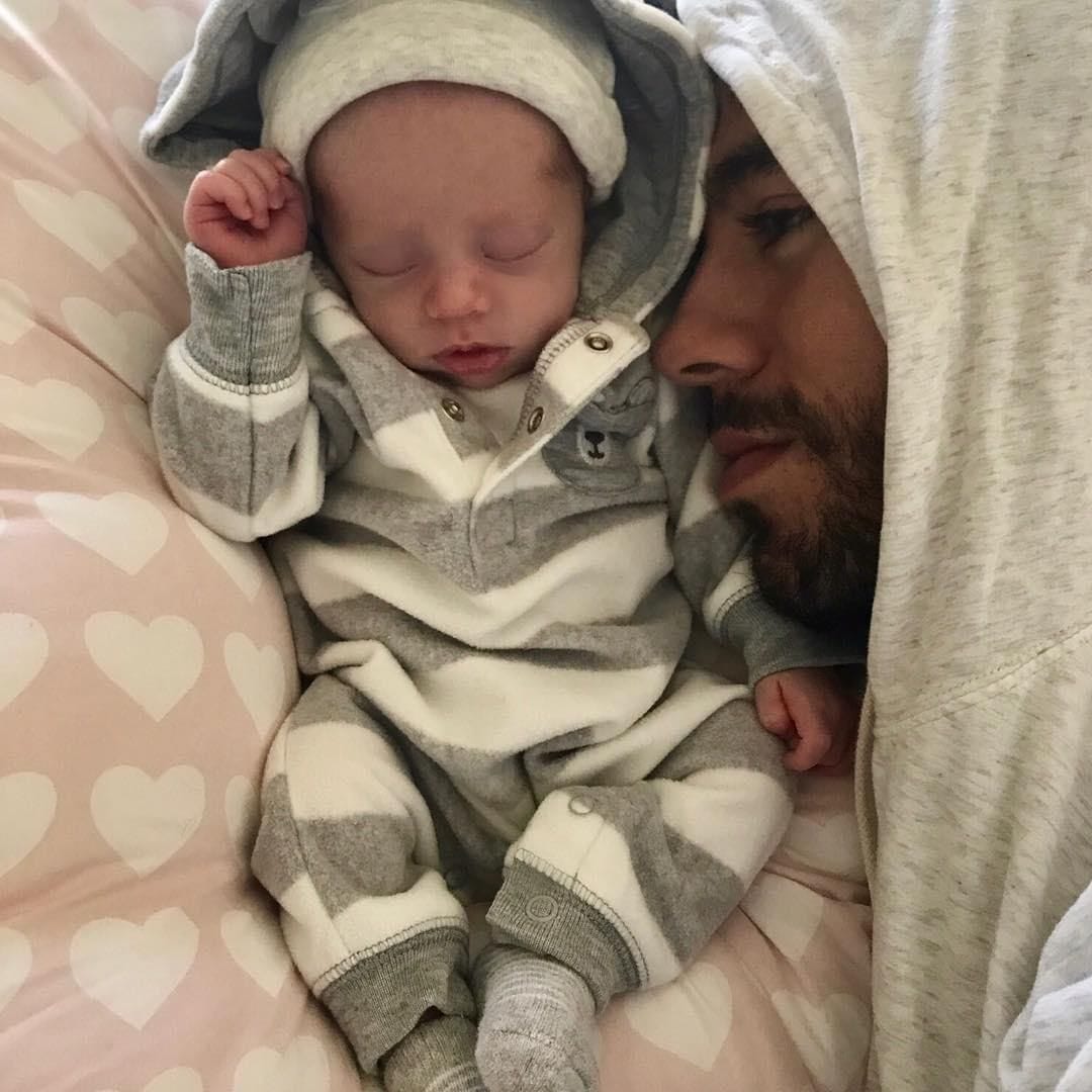 Enrique Iglesias posing with newborn baby