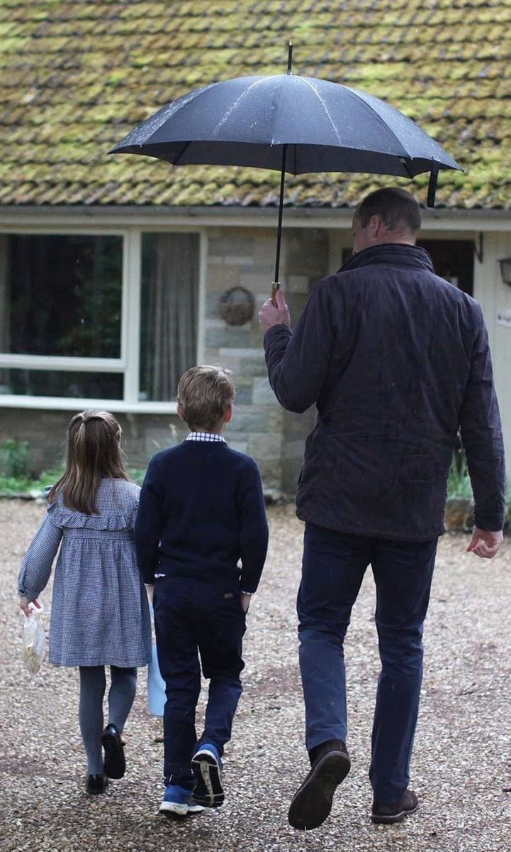 Kate Middleton's husband held an umbrella over his oldest children's heads while delivering food parcels to isolated pensioners amid the COVID-19 pandemic in 2020.