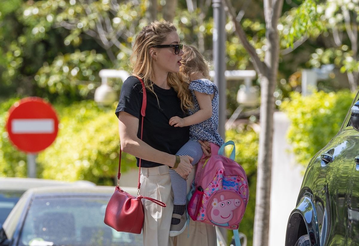 
37-year old The American Actress Amber Heard enjoys a walk through the Spanish streets of Madrid with her daughter as Amber seemed fully recovered and happy after injuring her hip while training for the annual New York City Marathon. 