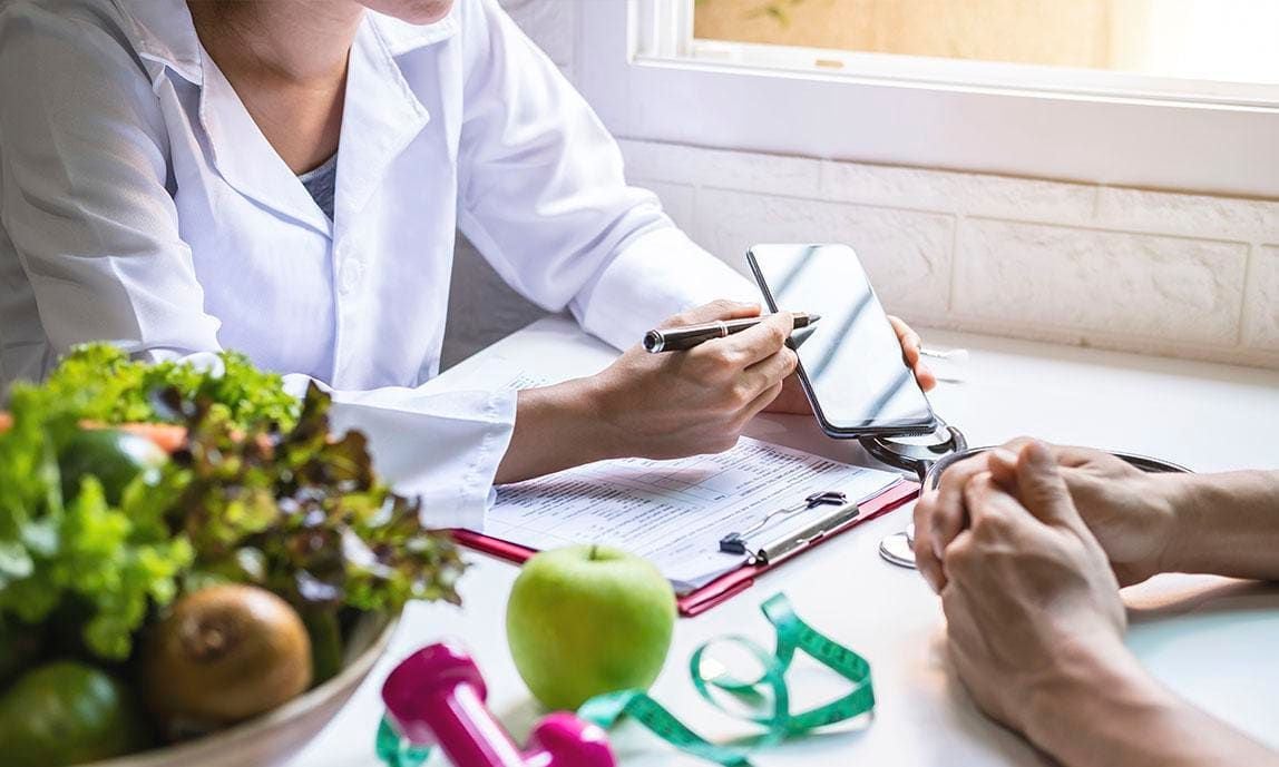 A nutritionist showing a patient data