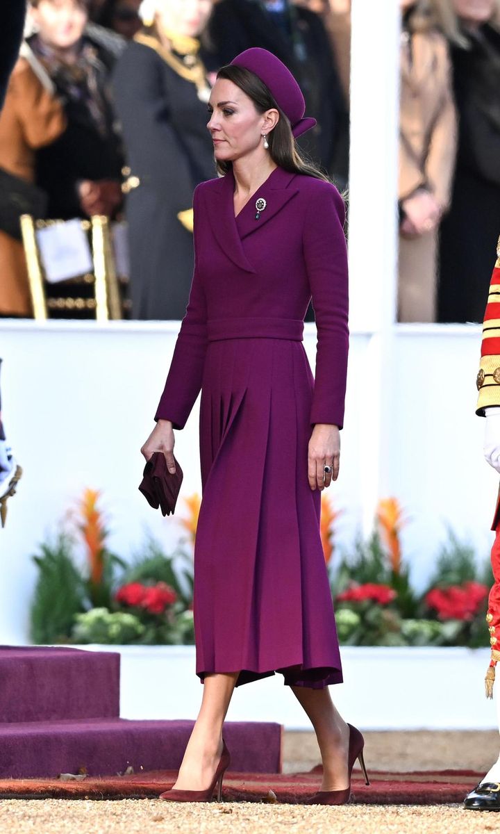 The Princess looked pretty in a head to toe plum ensemble. Catherine accessorized her regal look with Princess Diana's Collingwood pearl drop earrings and the Prince of Wales feather brooch.