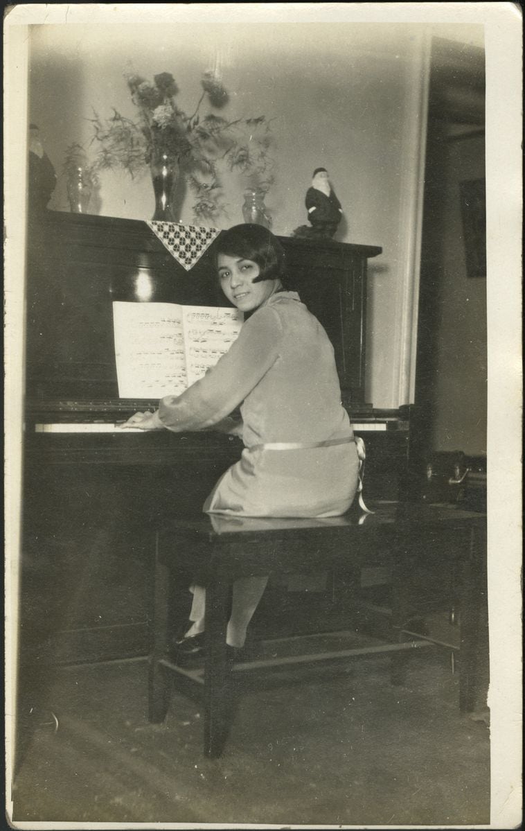 Clotilde Arias sitting at the piano in her Brooklyn, NY apartment, circa 1925. From the exhibition by national museum of american history, Not Lost in Translation: The Life of Clotilde Arias