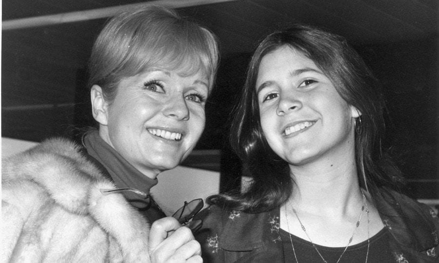 "I am truly a product of Hollywood inbreeding," Carrie (pictured with mom Debbie) penned in her 2008 autobiography <i>Wishful Drinking</i>. "When two celebrities mate, someone like me is the result."
Photo: Dove/Evening Standard/Getty Images