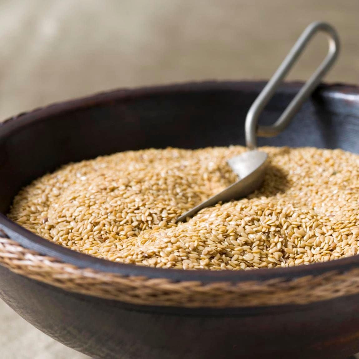 Uncooked brown rice in a wooden bowl