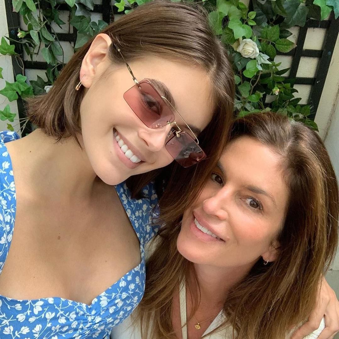 Kaia Gerber in sunglasses and a print garment and Cindy Crawford in whiten