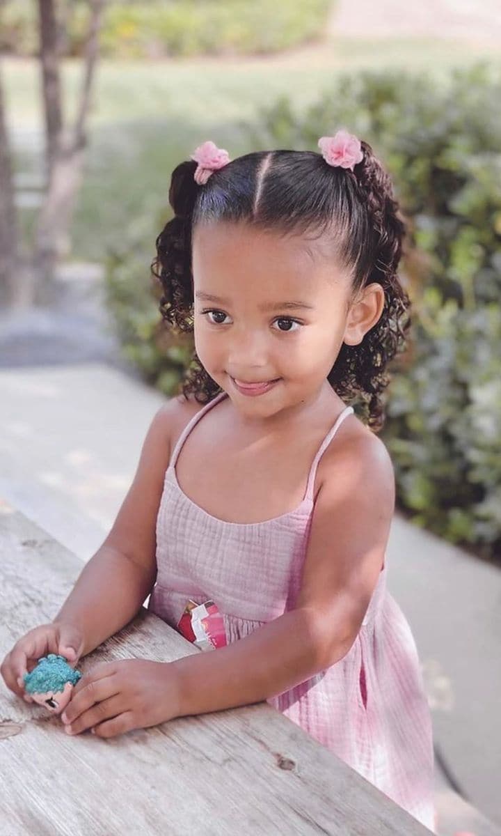Chicago West in a pink dress smiling.