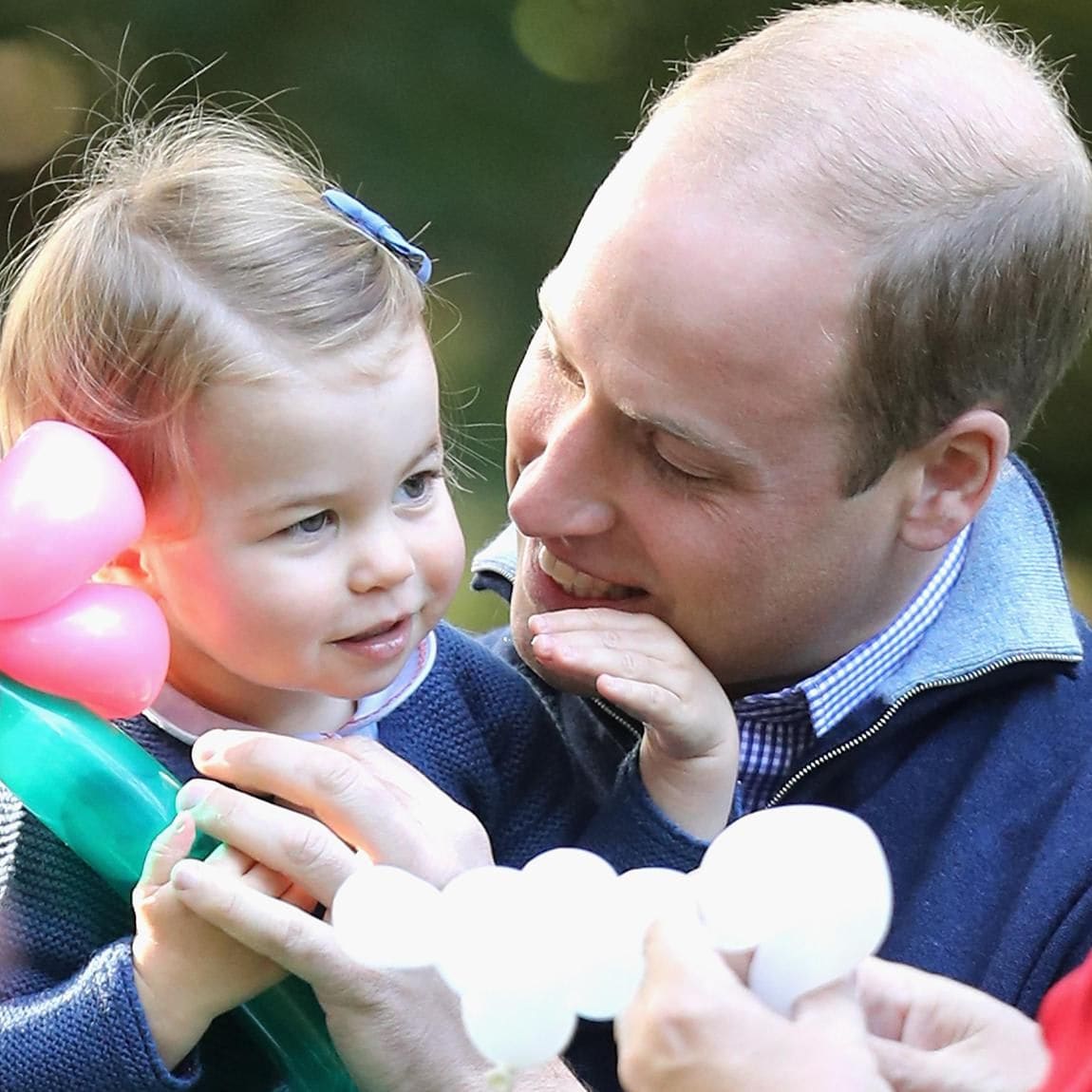 Charlotte was the apple of her father's eye at a children's party during the Cambridges' 2016 royal tour of Canada.