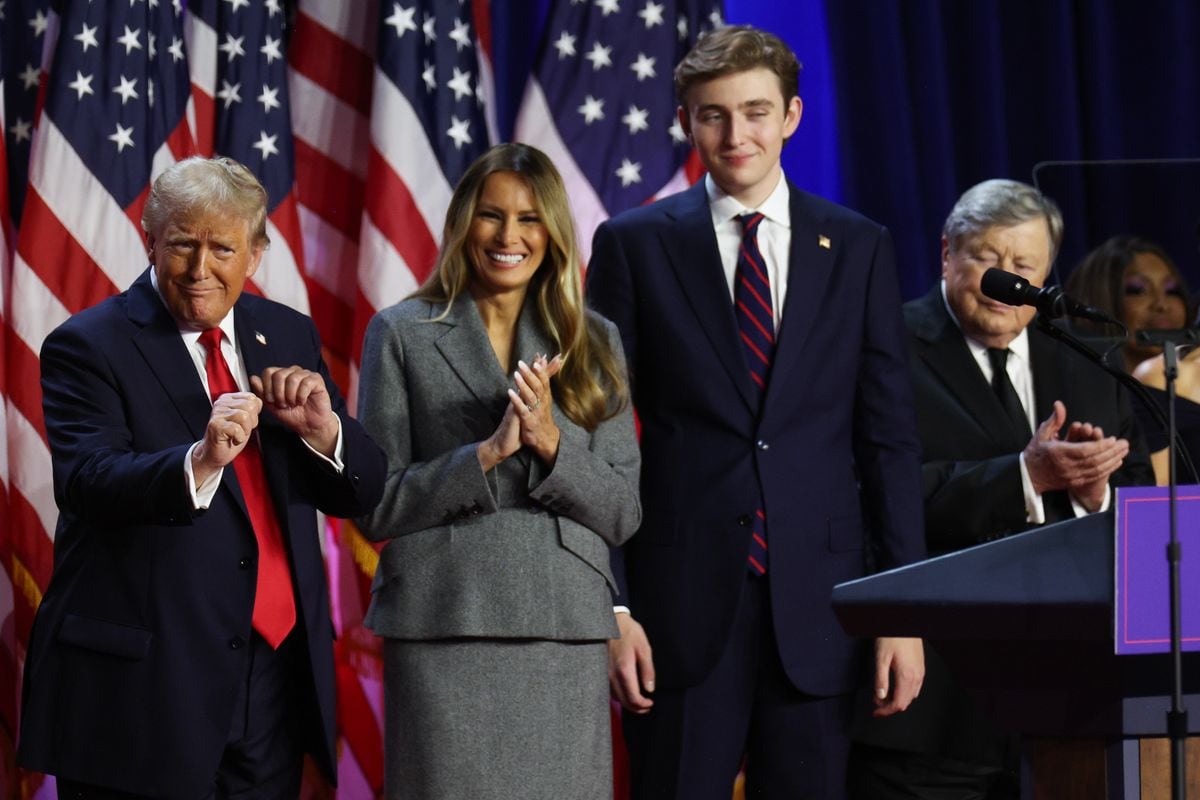 Donald Trump dances on stage with former first lady Melania Trump and Barron Trump during an election night event at the Palm Beach Convention Center on November 06, 2024 in West Palm Beach, Florida. Americans cast their ballots today in the presidential race between Republican nominee former President Donald Trump and Vice President Kamala Harris, as well as multiple state elections that will determine the balance of power in Congress.   (Photo by John Moore/Getty Images)