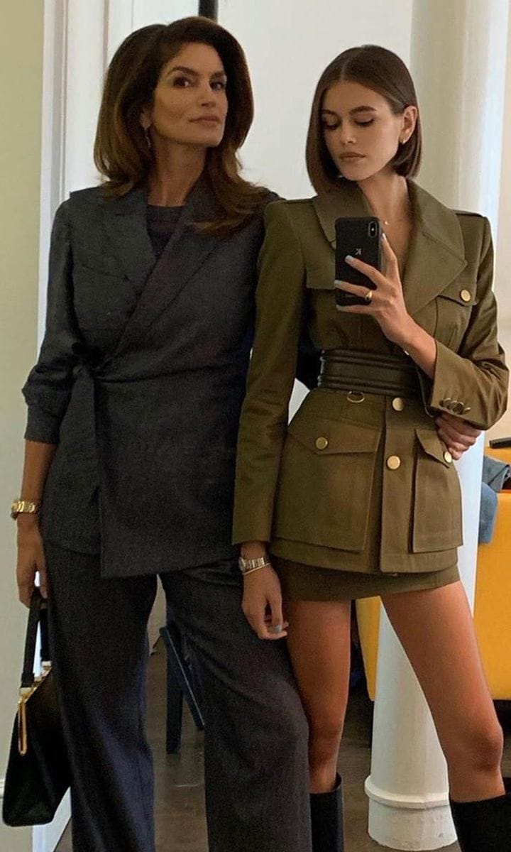 Cindy Crawford in a gray suit and Kaia Gerber in a maxi blazer, mini skirt, and high boots