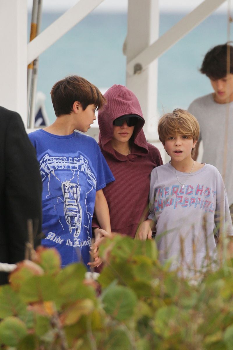 Shakira attempts to go incognito as she hits the beach with her sons on Christmas Day in Miami. 