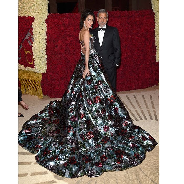 A gorgeous view of Amal Clooney's dramatic floral gown as she posed at the cocktail party with her best accessory husband George!
Photo: Kevin Mazur/MG18/Getty Images for The Met Museum/Vogue