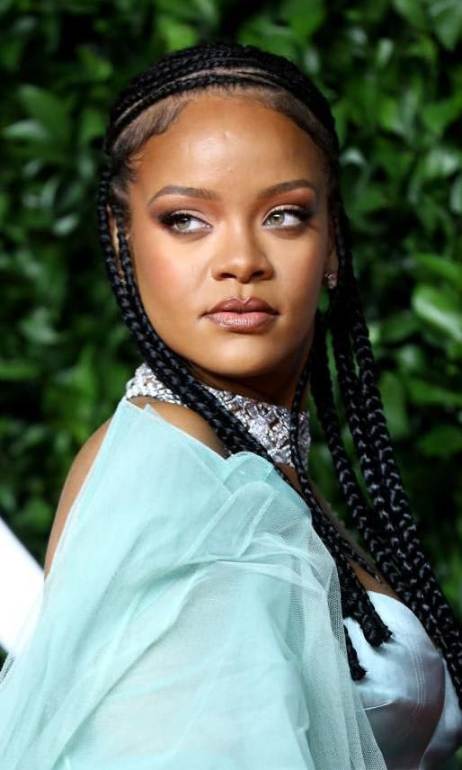 Rihanna with natural makeup and braids