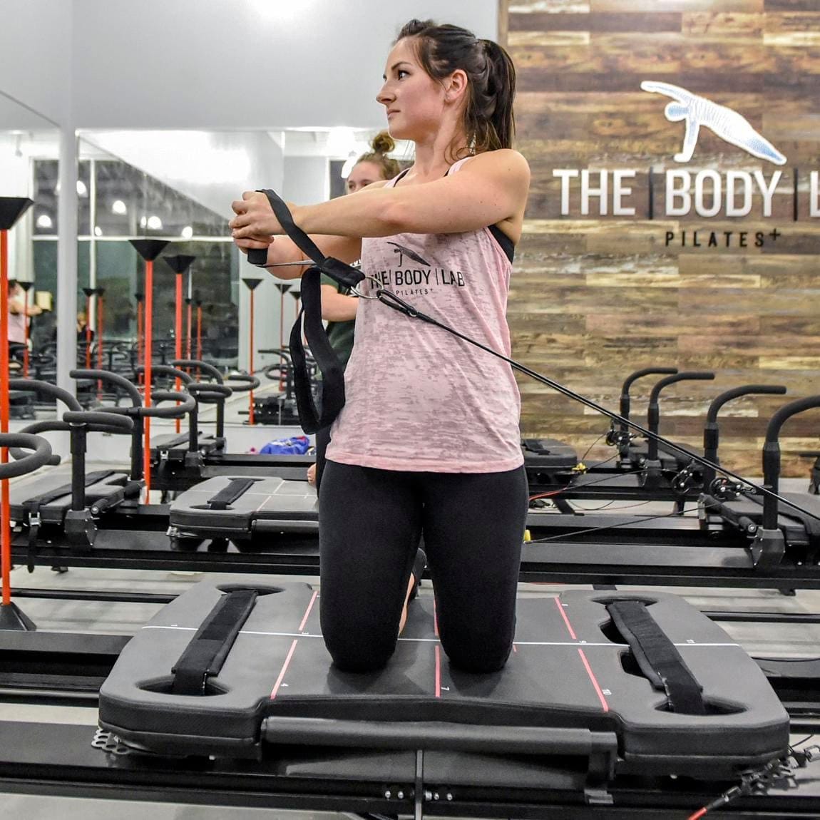 Woman training on the Megaformer with strapsn