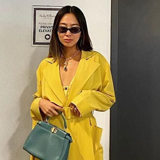 Aimee Song with sunglasses and mint-colored purse