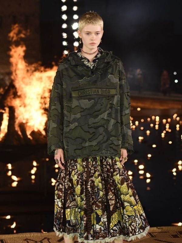 model wears camouflage print clothes on fashion catwalk