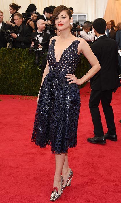 Tres chic! Marion donned a bold red lip with this gorgeous Christian Dior cocktail dress and Chopard jewelry at the 'Charles James: Beyond Fashion' Costume Institute Gala at the Metropolitan Museum of Art in New York City.
Photo: Larry Busacca/Getty Images