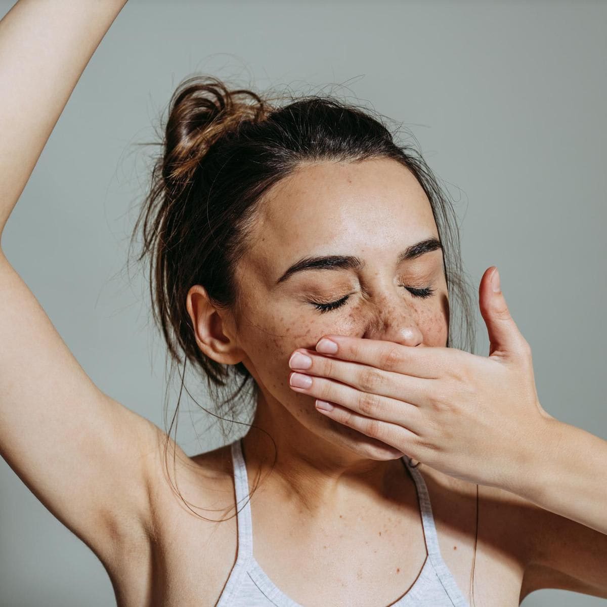 Photo of a young woman yawning; feeling tired
