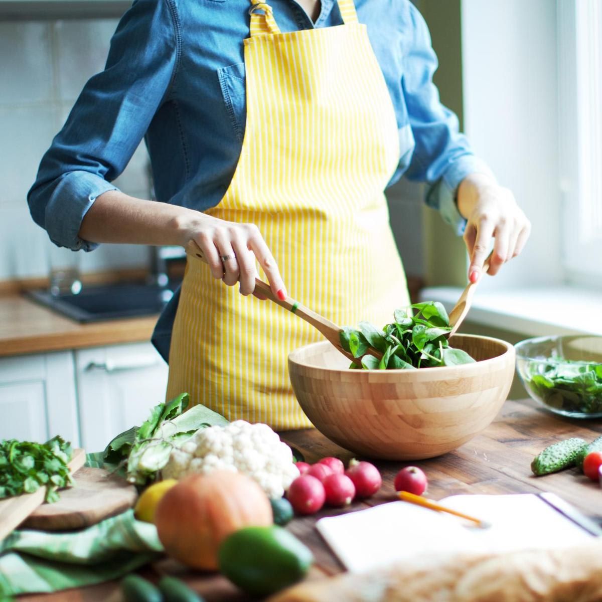 Woman cutting vegetables at the kitchen