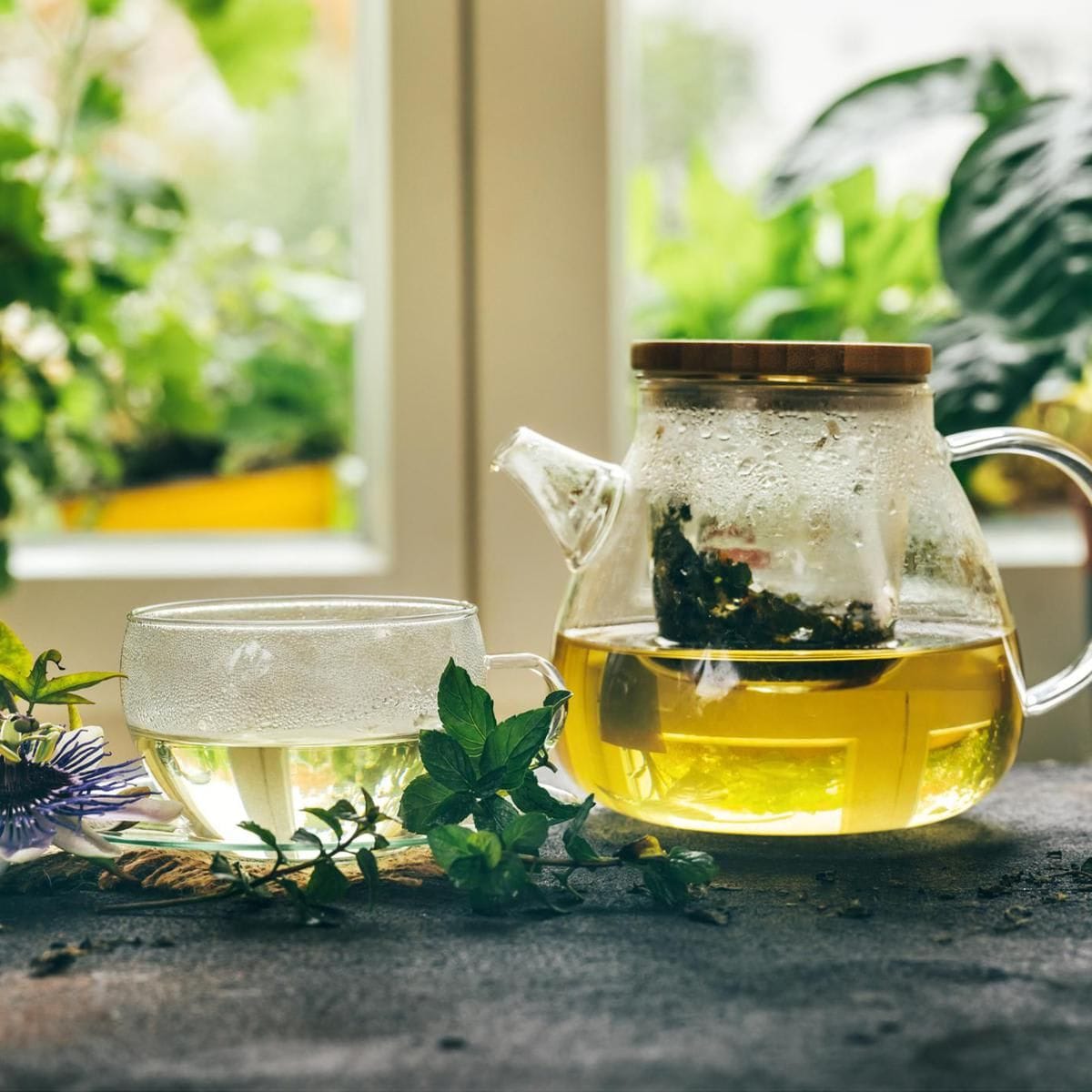 Cup of herbal tea from the leaves of passiflora on rustic background.