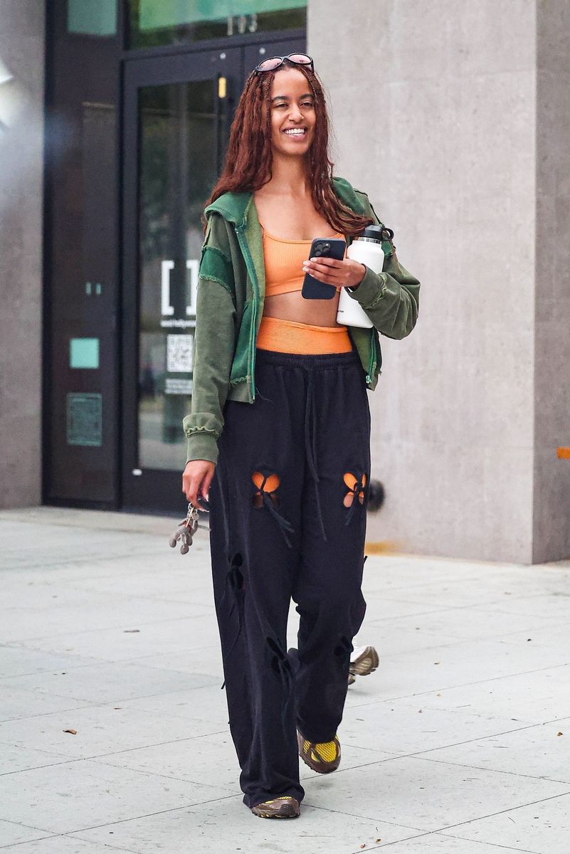 Malia Obama was seen leaving Solidcore gym with a friend, looking happy and refreshed after a workout. Malia looked radiant post-workout as she exited in an orange workout set showing off her toned midriff.