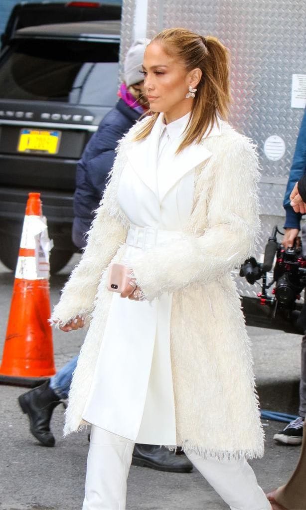 Jennifer Lopez in a long white coat, combining different white tones