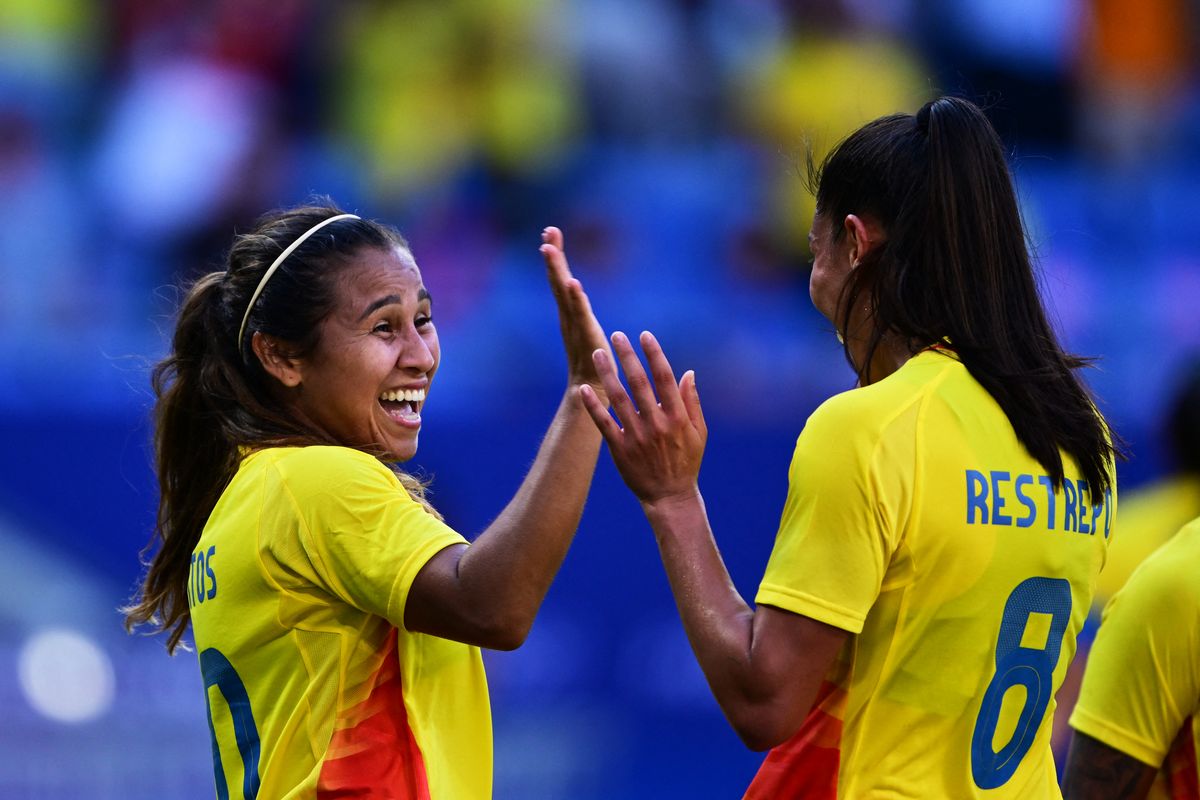 Colombia's midfielder #10 Leicy Santos  (L)  celebrates with  Colombia's midfielder #08 Marcela Restrepo after scoring her team's second goal during the women's group A football match between New Zealand and Colombia of the Paris 2024 Olympic Games at the Lyon Stadium in Lyon on July 28, 2024. (Photo by Olivier CHASSIGNOLE / AFP) (Photo by OLIVIER CHASSIGNOLE/AFP via Getty Images)