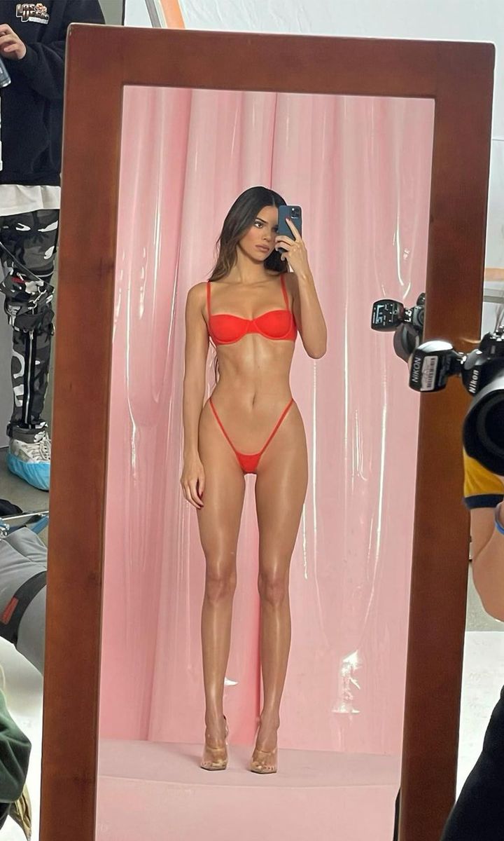 Kendall Jenner posing in red Skims
