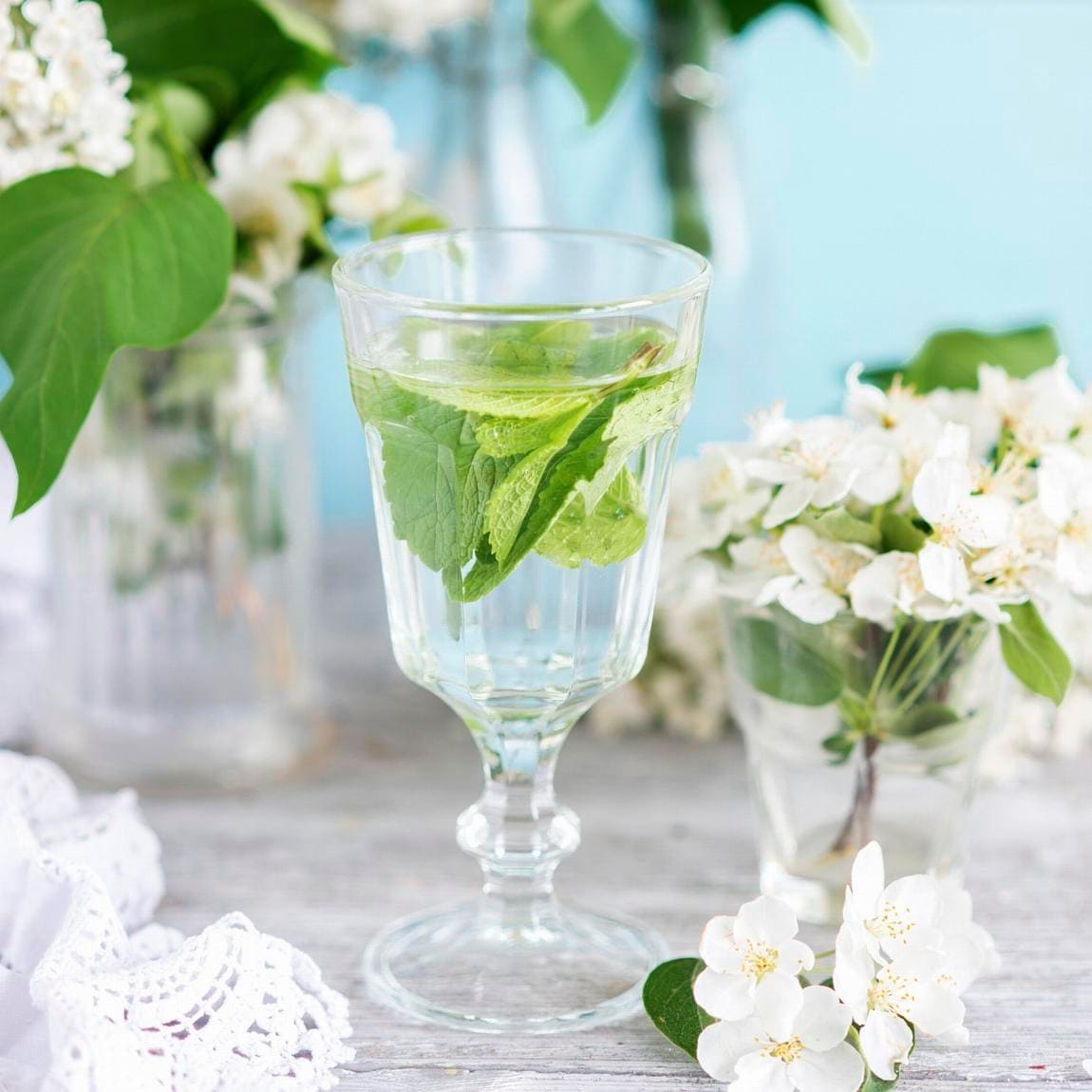 A glass of water with mint leaves