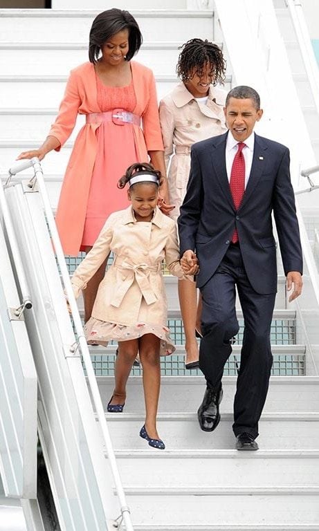 July 2009: Little ladies of fashion! Sasha and Malia were escorted by their parents in style as they wore neutral colored trench coats during a trip to Moscow.
<br>
Photo: Getty Images