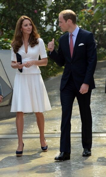 Kate looks every bit the professional in this white two-piece outfit while sharing a look with William.
<br>
Photo: Getty Images