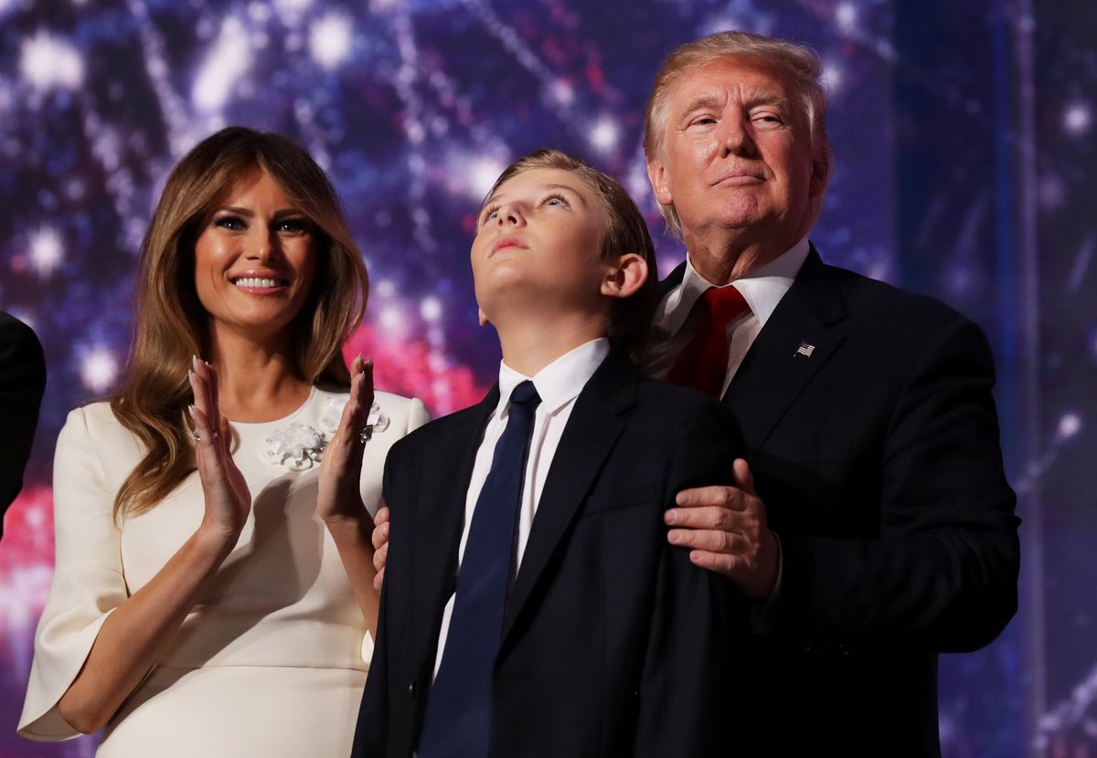 Donald Trump embraces his son Barron Trump, as his wife Melania Trump looks on at the end of the Republican National Convention on July 21, 2016 