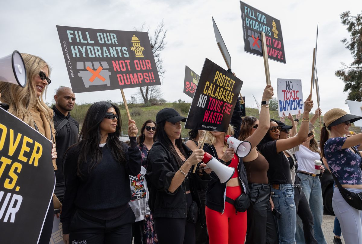 CALABASAS, CA - FEBRUARY 27: Kourtney Kardashian, second from left, joins protesters at Calabasas Landfill in Calabasas, CA on Thursday, Feb. 27, 2025. Residents oppose the disposal of fire debris citing the potential health hazard. County officials said they need to truck debris to the Calabasas, Sunshine Canyon and Lancaster landfills. (Myung J. Chun / Los Angeles Times via Getty Images)