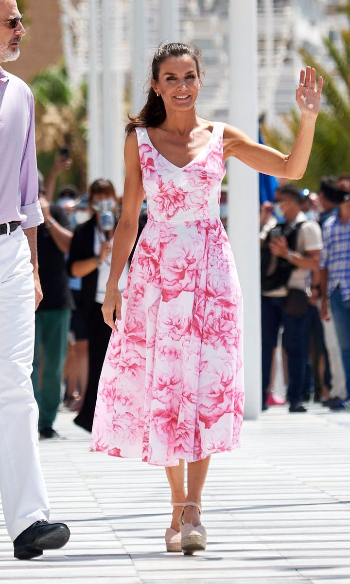 Letizia was pretty in pink wearing a previously worn floral print Adolfo Dominguez midi dress and Macarena suede espadrilles in Benidorm.