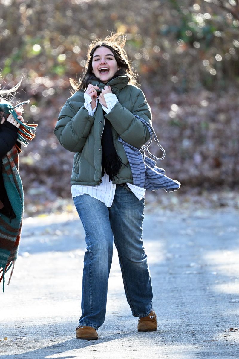 Suri Cruise jumps of joy with a friend on a visit to a Farmers Market in New York